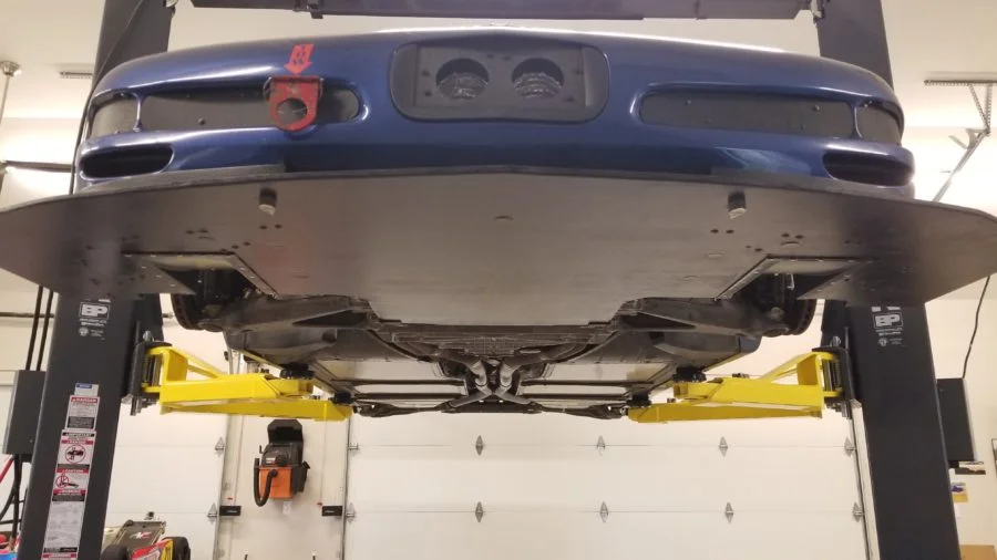 Chevrolet Corvette splitter showing a pair of Professional Awesome splitter diffusers installed near the front tires