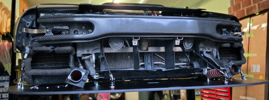 Front install detail of Professional Awesome Quick Release Splitter Support System with custom NSX chassis brackets on a 1995 Acura NSX-T