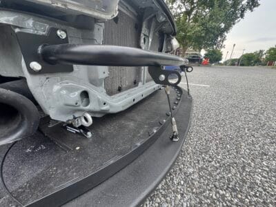 Close view of Civic Si Doryoku crash bar, quick-release splitter mounts, and support rods
