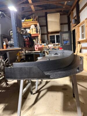 Front-edge view of the curved homemade carbon splitter for a 2000 Chevrolet Corvette C5