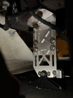 Close-up of a TrackCarAero splitter mount bolted to a factory tow-hook mounting location on Joseph Herr’s 2000 Mazda Miata NB