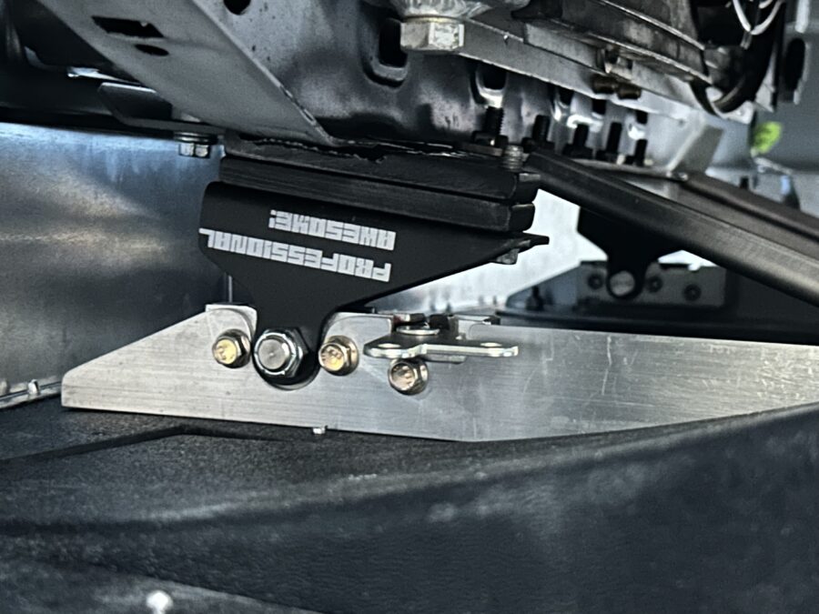 Professional Awesome quick-release splitter mount attached to a fabricated bracket beneath Drew’s BMW E30.