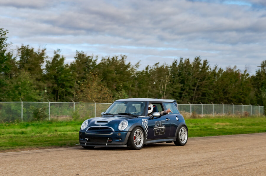Blue R53 MINI Cooper S JCW on track with its front splitter and support rods installed