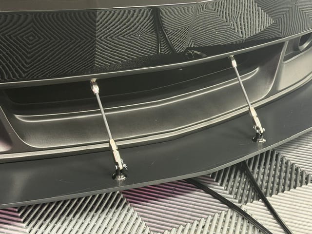 Pair of Professional Awesome support rods spanning the factory bumper opening and splitter on a 2012 Boss 302.
