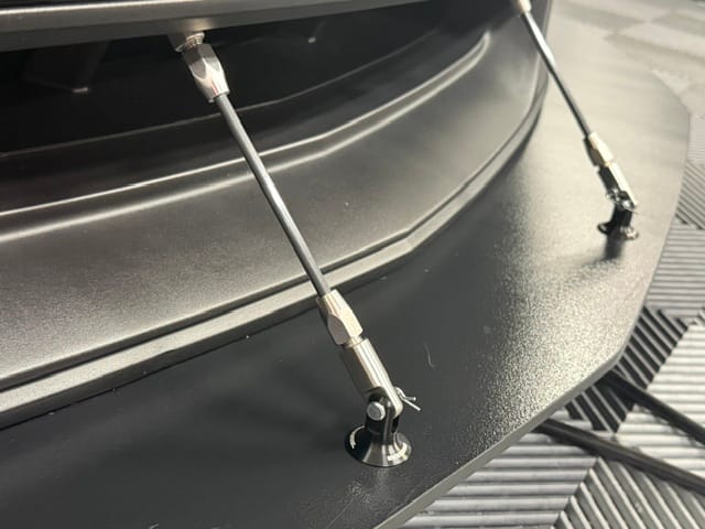 Close-up of a Professional Awesome splitter support rod and lower clevis mount on Jon’s Boss 302 Laguna Seca.